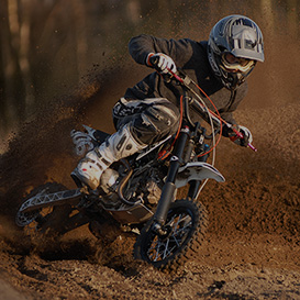 A driver drifting with a dirtbike in the mud